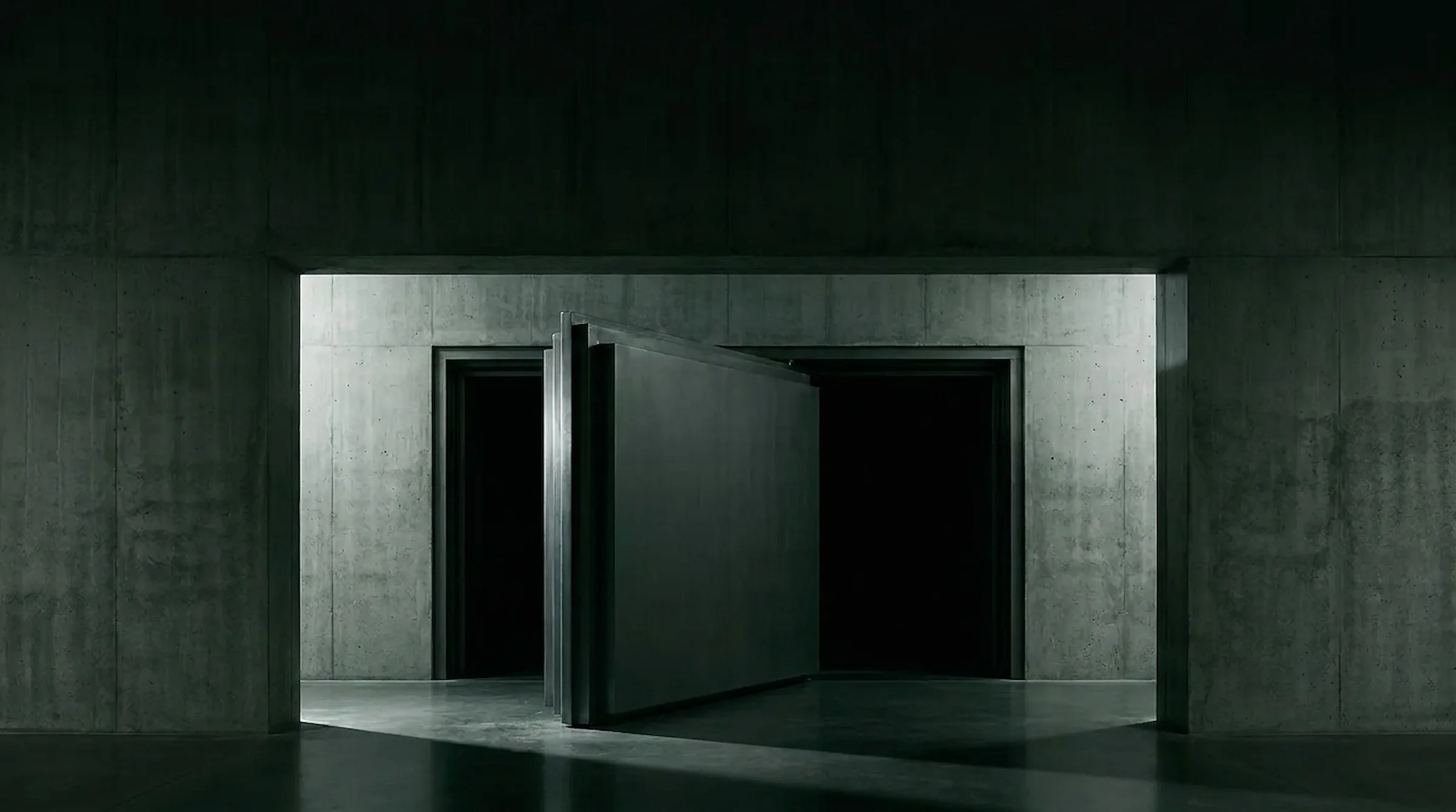 Massive sealed vault-like door set in dark concrete, a black gap of separation around its frame